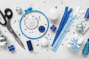 Composition with sewing supplies and Christmas decorations on light background
