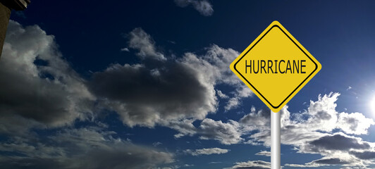  danger,caution,Hurricane Idalia warning sign against a powerful stormy background with copy space. Dirty and angled sign with cyclonic winds add to the drama.hurricane season sign on cloudy backgroun