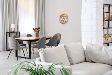 Comfortable sofa and wooden table in living room. Interior design