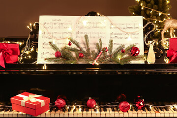 Red Christmas balls and gift box on piano