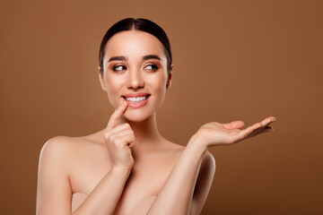 Portrait of gorgeous dreamy elegant lady no clothes facial makeup products empty space on beige...