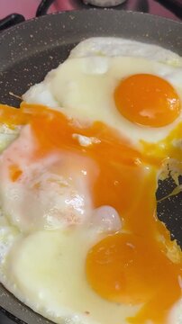 take an egg from the frying pan with a spatula Failed attempt to flip a sunny side up