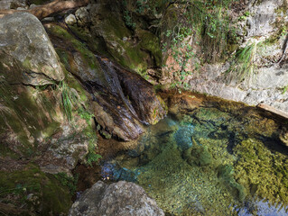 Torrent de Pastoritx, small gorge, waterfall with crystal clean clear water in nature, Valldemossa, Sa Raixa hiking route, Mallorca, Balearic Islands. Natural environment, spring hiking trail.