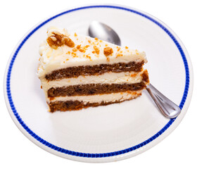 Piece of sweet carrot cake served with topping on plate. Isolated over white background