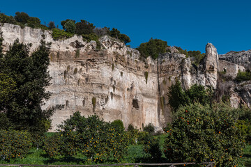 Beautiful garden with Mediterranean vegetation and numerous caves - Paradise stone quarry (Latomia del Paradiso). Syracuse, Sicily, Italy.