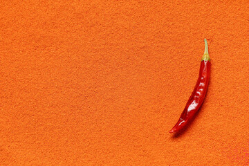 Pepper on red chili powder as background