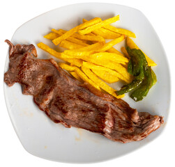 Roast beef tenderloin is complemented with portion of French fries. Isolated over white background