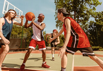 Fototapeta premium Diverse basketball team training for big match at ourdoor sportsground