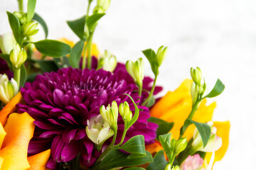 lilac dahlias with yellow roses in a bouquet on a light background close-up. bouquet of dahlias and roses