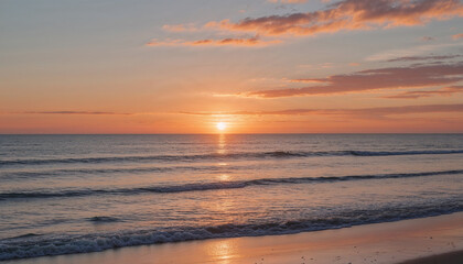 Fototapeta premium Golden hour at the beach with the sun setting over calm ocean waves, casting warm orange and pink hues across the sky and water, perfect for peaceful, romantic, or travel-themed visuals.