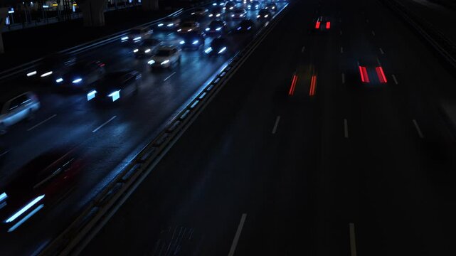 Сinematic shot of highway traffic at night, captured with a slow shutter speed
