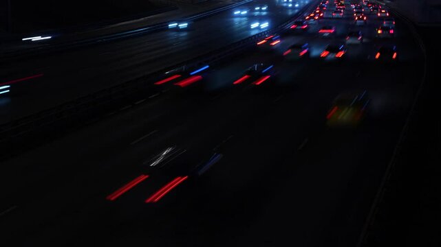 Сinematic shot of highway traffic at night, captured with a slow shutter speed