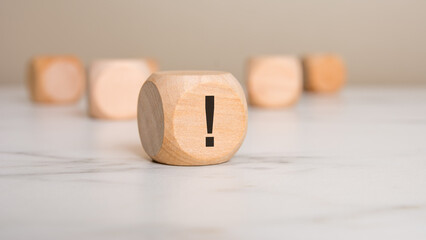 wooden block with an exclamation mark, symbolizing alert, warning, or important attention notice