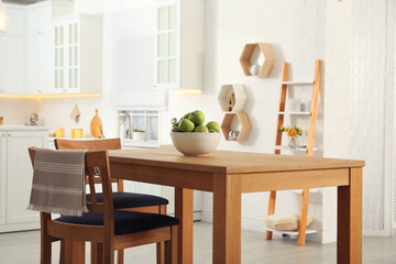 Stylish dining table and chairs in kitchen. Interior design