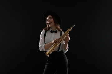 Obraz premium Musician with soprano saxophone on dark background