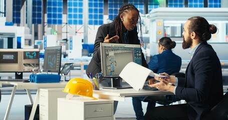 Photovoltaics factory manager visualizes solar cells designs with 3D software tools, talking with...