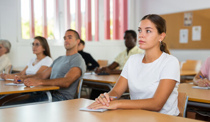 Attentive university students in advanced training courses in the auditorium