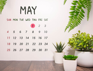 May 1st. Image of may 1 wooden calendar on the table.