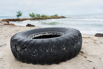 Abandoned truck tire on a beach on the Colombian coast.