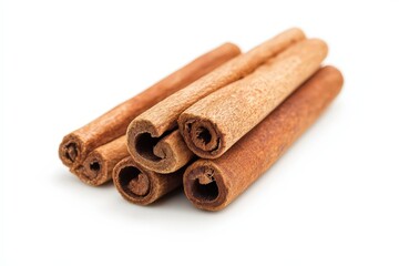 Several sticks of cinnamon are shown on a white background