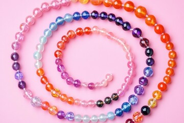 Fototapeta premium Colorful Bead Necklaces and Bracelets on a Soft Pink Background