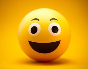 Fototapeta premium A happy emoji ball on a yellow background