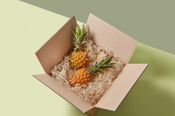Fresh pineapples in a delivery box