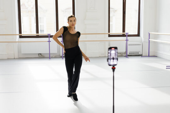 Dance teacher broadcasting dance lesson for her students from phone