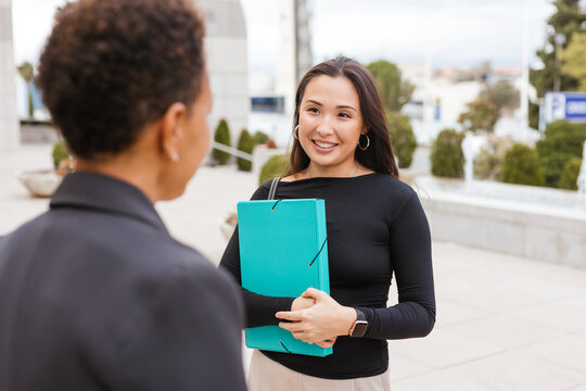 An Asian woman smiles during a conversation