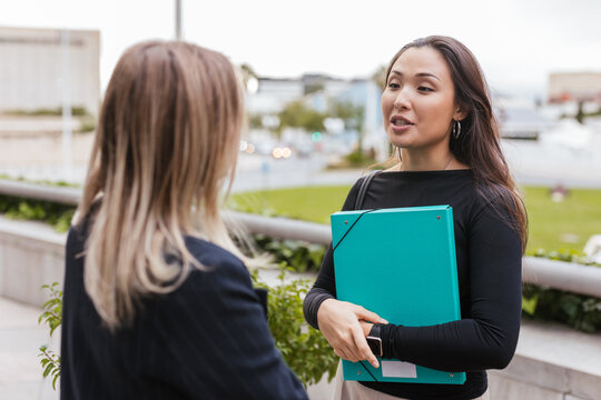 a couple of young working women talking