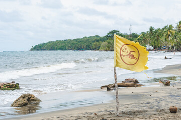Yellow warning flag on the beach