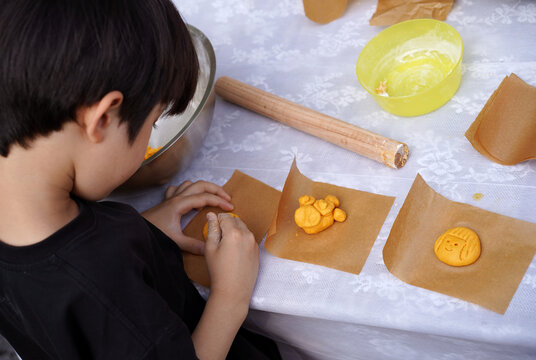 A Chinese boy making cookies in the garden
