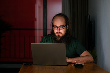  Focused Man Working Late on Laptop