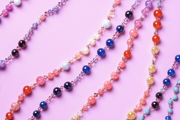Colorful Beaded Necklaces and Bracelets on Purple Background with Copyspace for Hobbies and Crafts