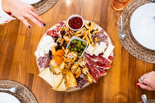 Sharing platter with cheese, cold cuts, walnuts, olives, bread