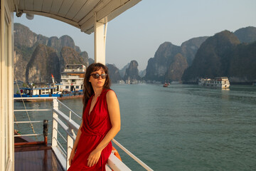 Elegant Woman in Red Dress on Ha Long Bay Cruise