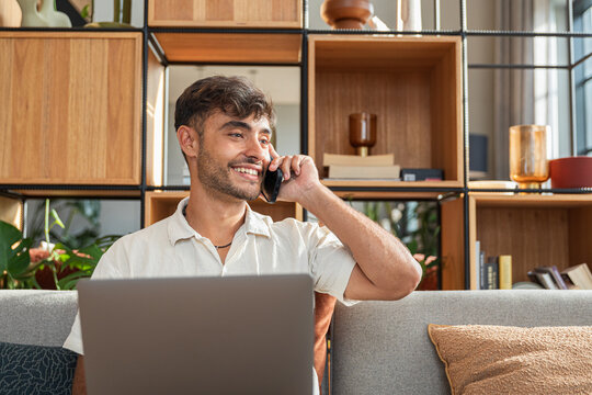 Happy man making a phone call while relaxed