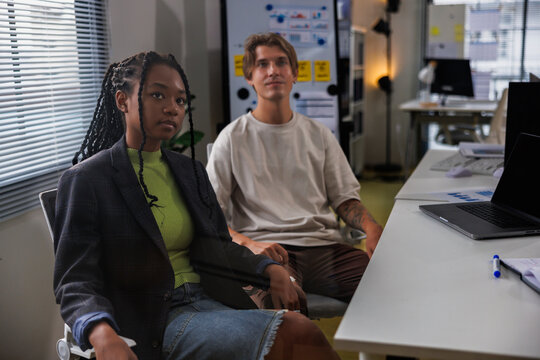 Diverse male and female colleagues in meeting at office