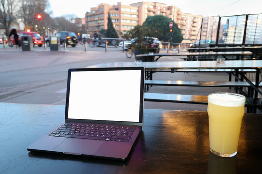 Laptop and Beverage at Caf&eacute; Outdoor During Rush Hour 