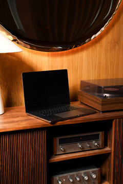 Laptop and Turntable on Wooden Console