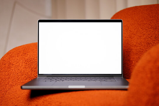 Laptop mockup on an red designer chair