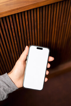 Mockup phone with white screen Against Wooden Panel