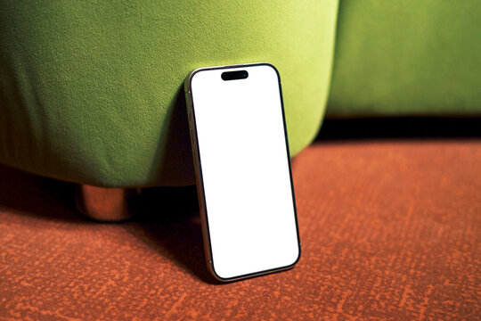 Phone Mockup with white screen Against Green Chair