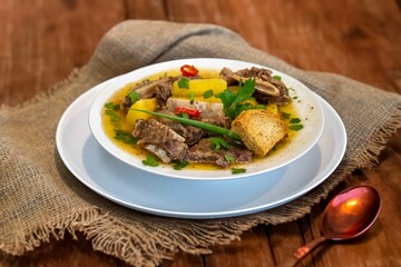 Traditional rustic Brazilian soup known as vaca atolada, prepared with cassava and beef ribs