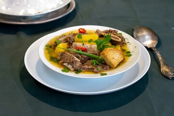 Traditional rustic Brazilian soup known as vaca atolada, prepared with cassava and beef ribs