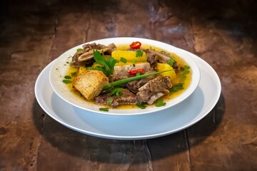 Traditional rustic Brazilian soup known as vaca atolada, prepared with cassava and beef ribs