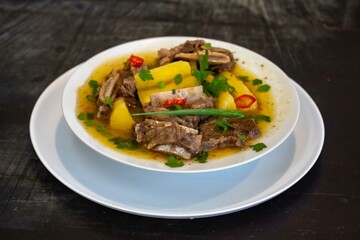 Traditional rustic Brazilian soup known as vaca atolada, prepared with cassava and beef ribs