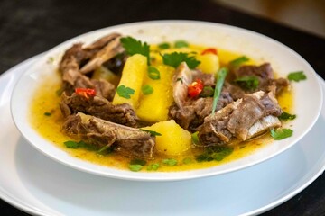 Traditional rustic Brazilian soup known as vaca atolada, prepared with cassava and beef ribs