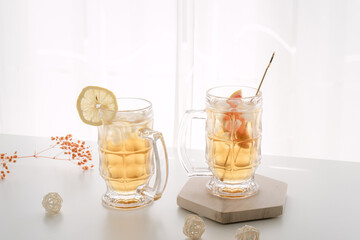 Two glasses of refreshing highball cocktails with lemon and fruit