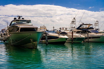 Fototapeta premium Yacht sailing on sea waters. Luxury superyacht at sea. Miami Beach with yachts. Seascape with a sailboat. Cruise ship near the coastline. Sunset yacht voyage in Florida. Luxury sailboat yacht.